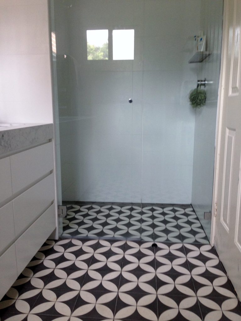 Geometric black and white mosaic floor tiling in Lillyfield