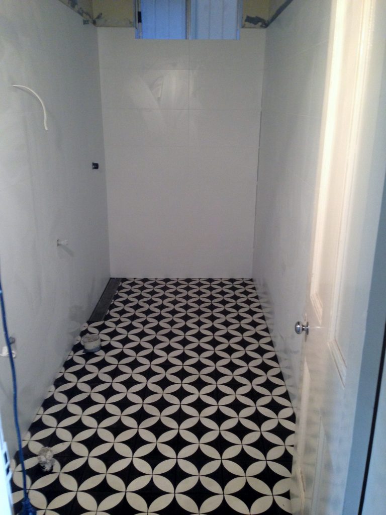 Geometric black and white mosaic floor tiling in Lillyfield