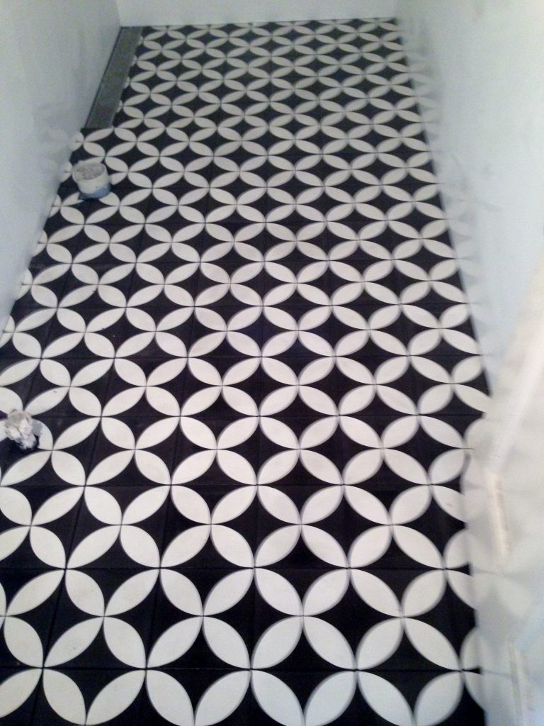 Geometric black and white mosaic floor tiling in Lillyfield