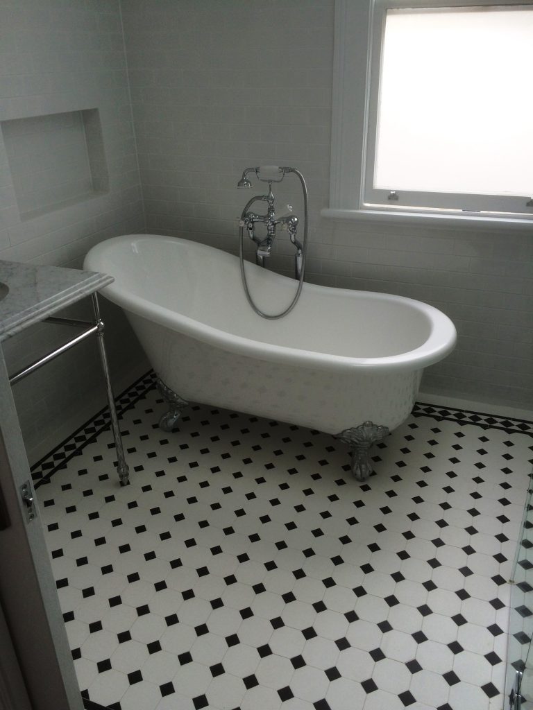 Bathroom renovation with freestanding bath and patterned floor tiles in Paddington