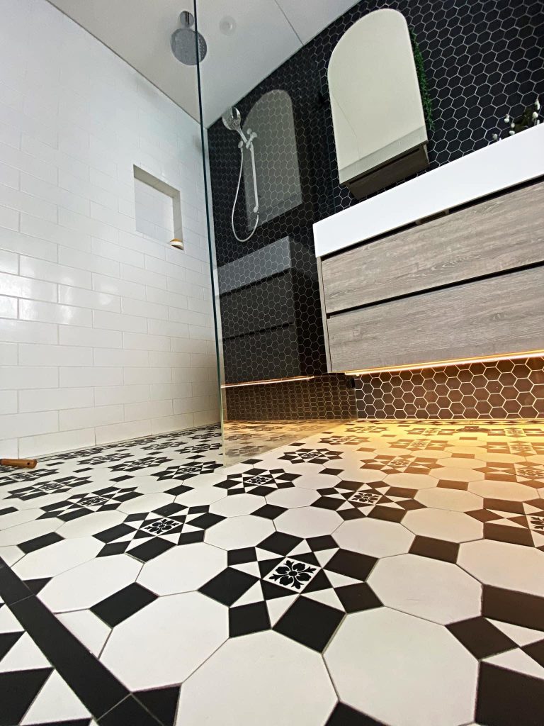 Bathroom renovation with tessellated floor tiling and timber vanity in Sydney Inner West