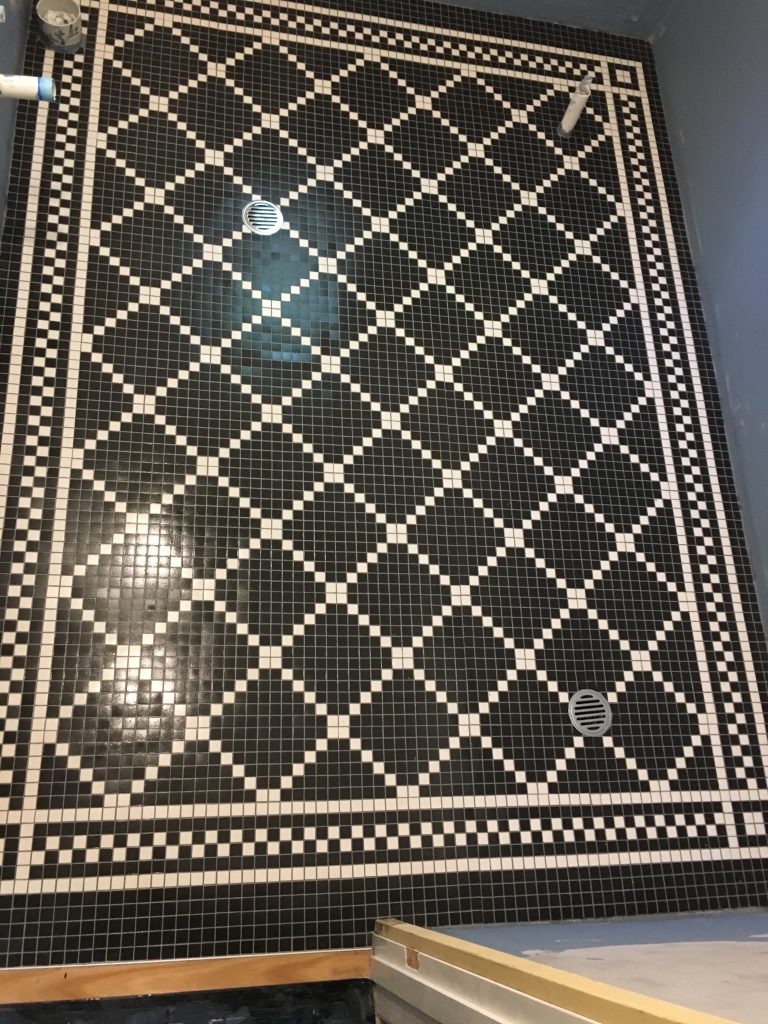 Black and white mosaic shower floor tiling in Drummoyne
