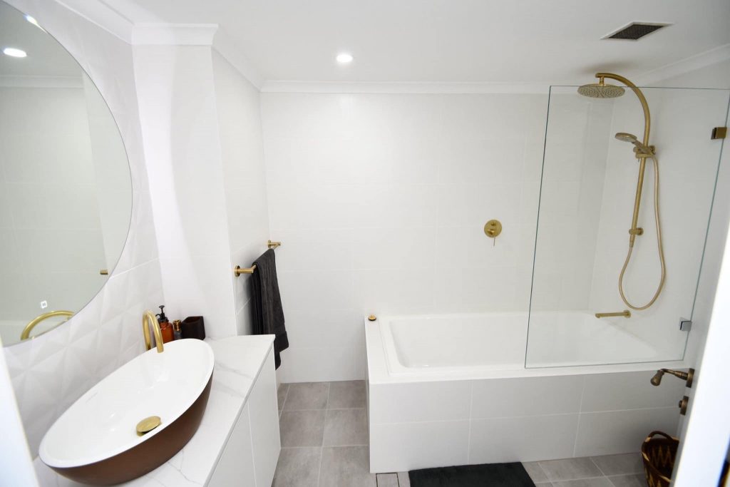White bathroom renovation with bathtub and wall tiling in Sydney CBD